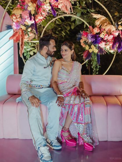 A beautiful shot of the couple on their decorated seating.