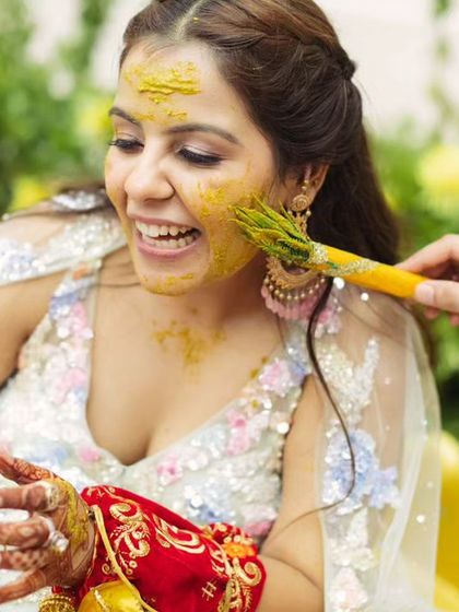 More Haldi fun. The bride's smile says it all.