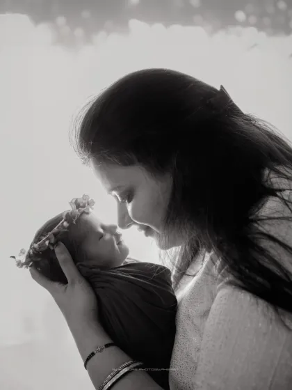 There is no safer place than a mother's arms. I create soft, intimate portraits like this black and white image to capture the profound, unspoken bond between you and your baby.
