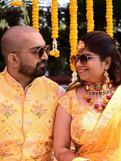 Twinning for the win. I love creating custom-coordinated outfits for couples, like this vibrant yellow lehenga and matching waistcoat for a Haldi ceremony. We can play with colors and designs to create the perfect look for you both.