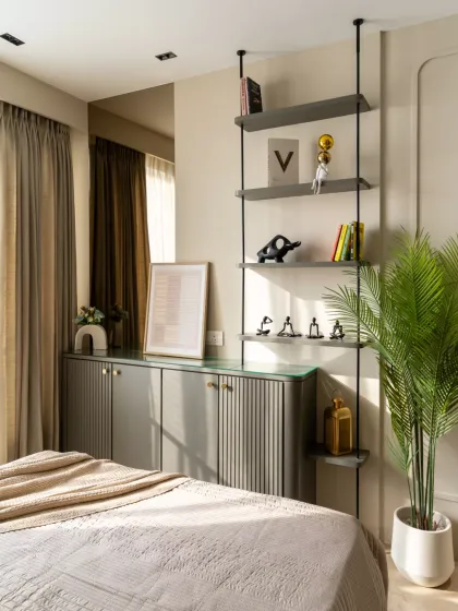 This elegant accent wall detail blends sleek floating shelves, curated décor, and soft neutral tones, adding depth and character to the space. The mix of modern aesthetics with warm textures creates a perfect balance of style and comfort.