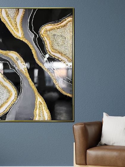 This black, grey, and gold resin art piece is the epitome of modern luxury. The abstract, flowing patterns resemble natural agate, with glittering crystals adding texture and shine.