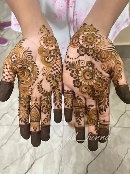 This Arabic mehndi design covers the palms with a mix of floral and paisley elements. The dark-tipped fingers are a traditional touch that my cones create perfectly.