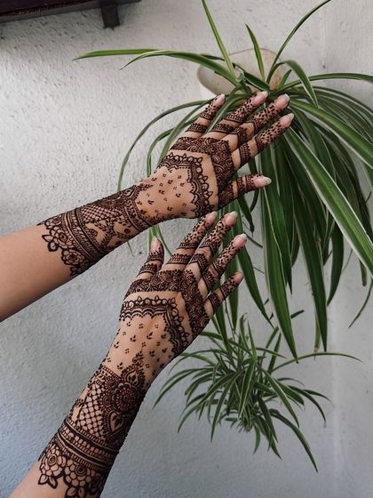 A modern take on bridal mehndi, this design features geometric chevrons and delicate dot work, creating a lighter, more contemporary feel.