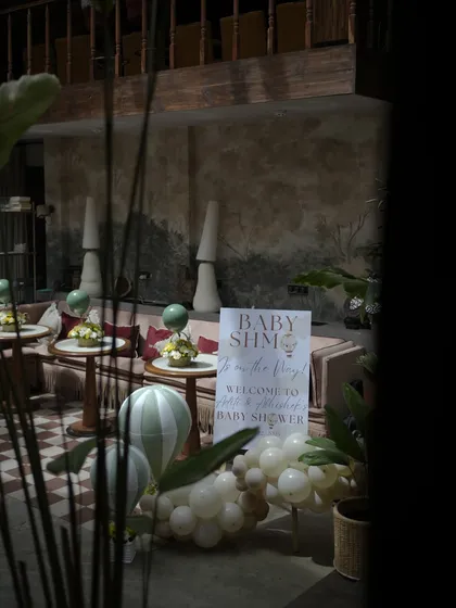 A glimpse of the event space, showing how our decor elements like the welcome sign and centerpieces integrate seamlessly with the venue's aesthetic.