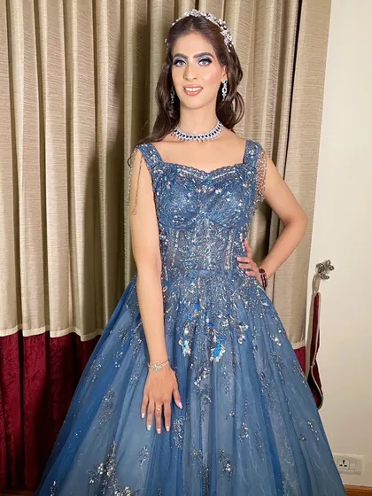 Killing it for her cocktail party! This bride is wearing a magnificent blue ball gown, and we paired it with a dramatic silver and blue smokey eye for a true showstopper effect.