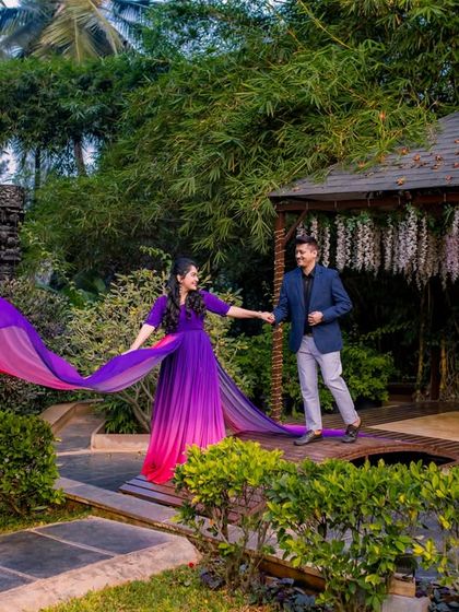 A beautiful shot of a flowing purple and pink gown on the wooden bridge in our garden.