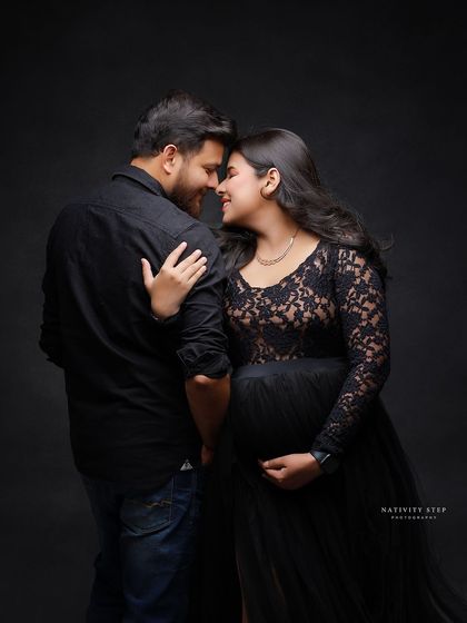An intimate and romantic couple's portrait. The dark background and their close embrace create a feeling of being in your own little world.