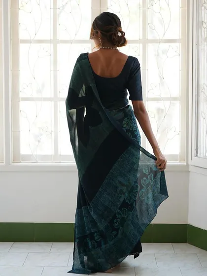 This is our hero item. The Nilā saree embodies our craft. It is a deep indigo silk georgette piece that took over 60 hours to create, combining intricate textures and custom-carved floral motifs using a specialized discharge printing technique.