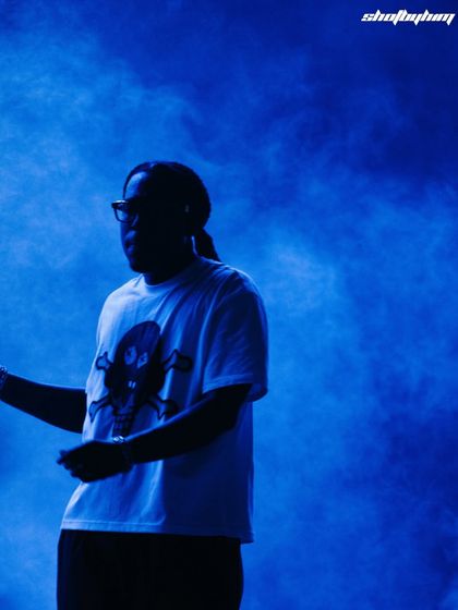 A silhouette of Don Toliver against a hazy blue background at Rolling Loud India. This artistic shot uses smoke and light to create a moody and atmospheric concert photo.