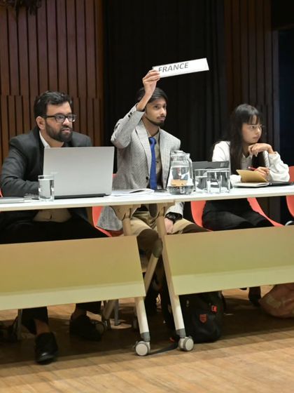 Delegates representing different countries during the French MUN session. The setup mimics a real UN conference, providing an immersive and professional experience for our students.