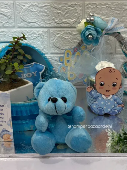 The little blue teddy bear adds a soft and cuddly touch to the hamper.