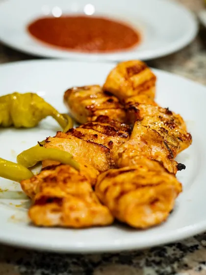 A simple, delicious-looking plate of chicken kebabs with grilled peppers. The focus is purely on the perfectly grilled meat.