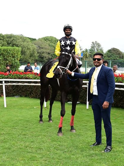 Mayne Magic and its owner stand proudly in the paddock after winning The Karnataka Mile Championship Cup.