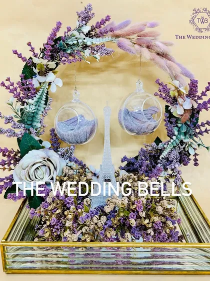 The complete Paris-themed engagement ring platter, set in a mirrored gold tray and adorned with a wreath of lavender flowers.