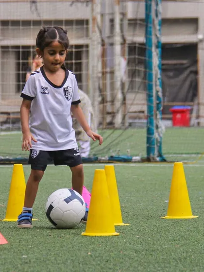 Navigating a field of cones, this U6 player is learning the basics of dribbling. Our philosophy is that everything is practice, and every moment on the field is a chance to learn.