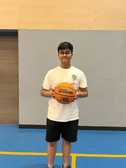 A happy participant from our summer basketball camp. Our camps are all about improving skills and having fun.