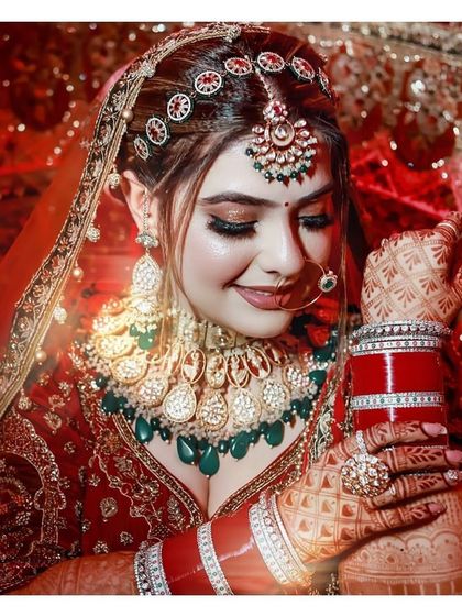 Our beautiful bride Shweta looking flawless in a red and green polki set with a unique red and white stone mathapatti.