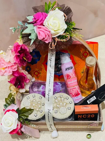A close-up view of the cosmetics and floral arrangement in this bespoke hamper. Every detail is carefully considered to create a stunning visual impact.