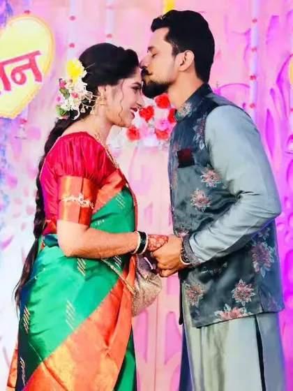 The groom-to-be affectionately kisses his bride's forehead during their engagement.