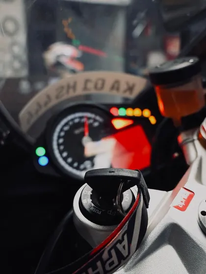 A cockpit view of an Aprilia, with the rev counter lit up. The anticipation before you head out on track is a feeling like no other.