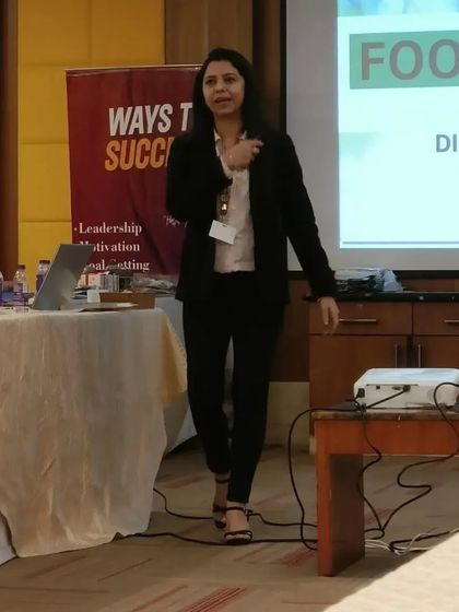 A candid moment of me walking the stage, connecting with the audience during a corporate wellness talk. My aim is to be an approachable guide on their health journey.