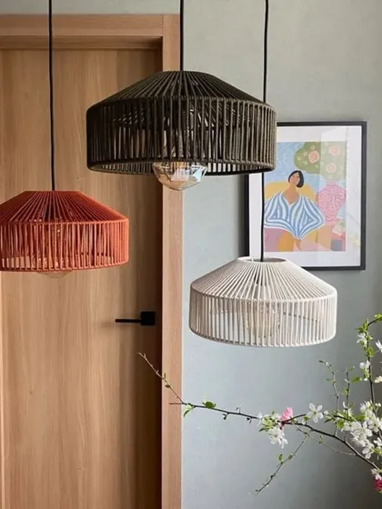 A trio of our modern, drum-shaped pendant lights in earthy tones. The slatted design allows light to peek through, creating a subtle striped pattern that adds visual interest to any room.