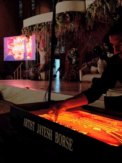 A glimpse of my performance during a family function at the Conrad Hotel in Pune. The dark stage and illuminated lightbox create a magical atmosphere.