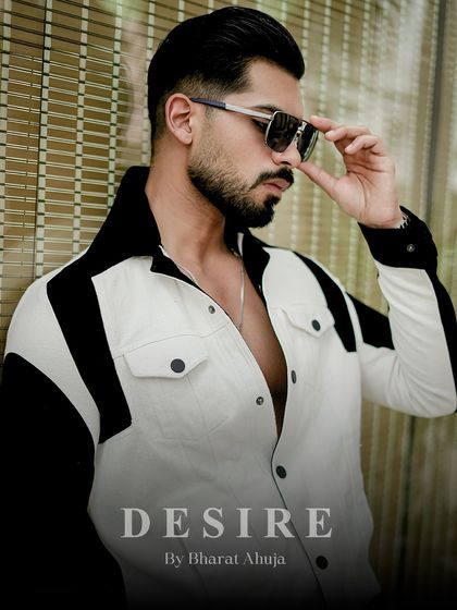 A closer portrait in the black and white jacket, highlighting the sharp tailoring and the confident presence it creates.