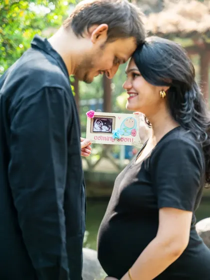 Sharing a sweet secret. This couple holds up their sonogram picture, a precious preview of the little one they're so excited to meet.
