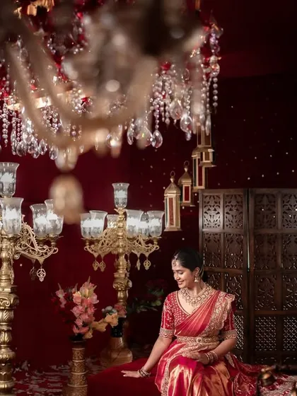 I love crafting portraits that feel both grand and personal. Here, the bride sits like royalty, surrounded by the warm glow of chandeliers, a timeless image of elegance and anticipation before her new beginning.