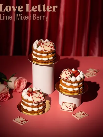 A "Love Letter" layered cake for Valentine's Day. The creative concept and styling tell a story.