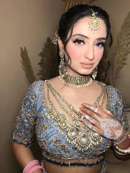 A close-up showing the delicate pearl details in the kundan jewelry, which adds a soft, romantic touch.