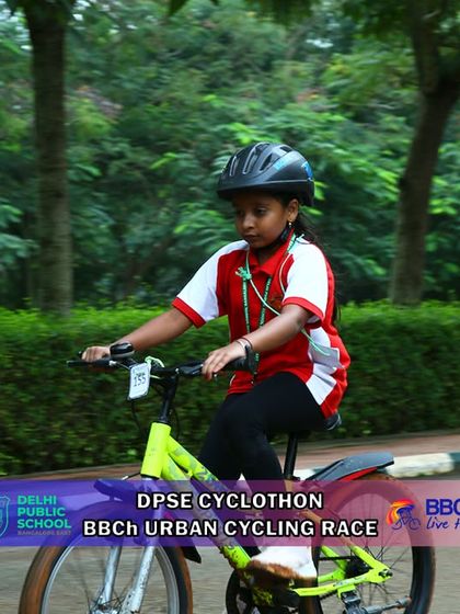 A young girl pedals with focus and determination along the paved section of the urban race course. My events welcome and celebrate the participation of young female athletes.