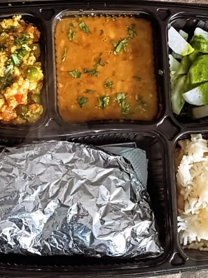 A delicious thali with Dal Tadka and Paneer Bhurji with peas. The side of fresh radish salad adds a nice crunch to the meal.