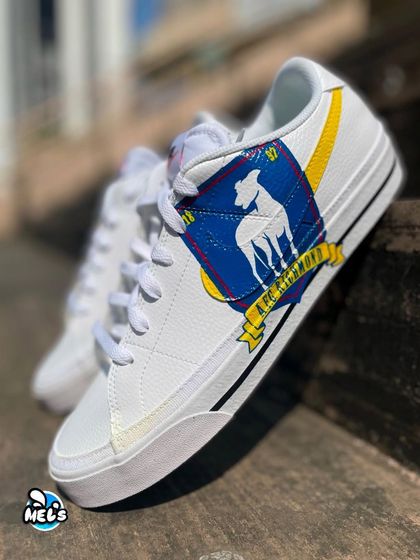 A stylishly angled shot of the AFC Richmond custom sneaker, highlighting the detailed crest artwork.