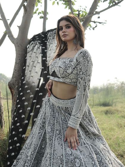 A powerful pose in this black and white embroidered lehenga, perfect for the modern bride or wedding guest.