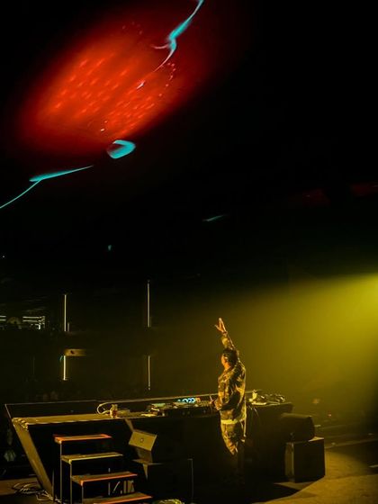 A dramatic shot of me on the elevated stage at Quake in Hyderabad, with a single spotlight.