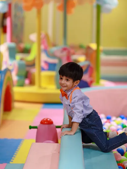 Dressed up for his Blippi-themed birthday party, this little one is ready to climb and explore the play structure.