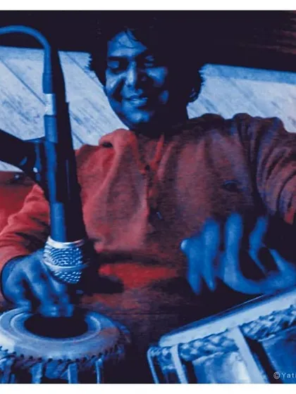 An artistic, blue-tinted photograph from a performance at 'The Submarine'. This captures the dynamic motion of my hands on the tabla during an energetic piece.