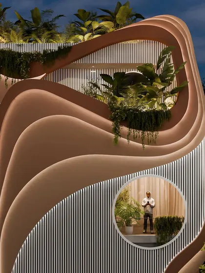 A detail shot of the "Water & Wind" facade at night, with the integrated lighting emphasizing the depth and complexity of the layered curves.