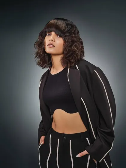 The same "Beatniks" look, but with textured, wavy hair. The makeup remains consistent, proving its versatility to adapt to different styling while maintaining a polished, commercial finish.