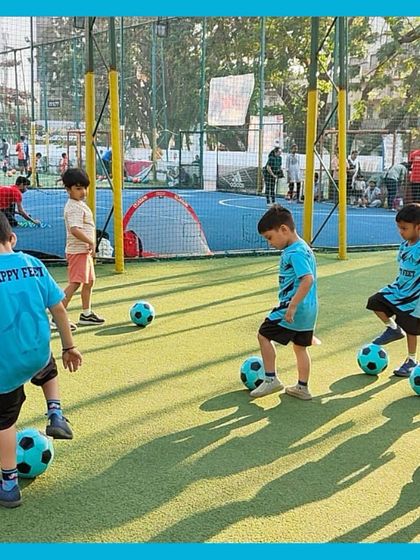 A typical day at our kids football camp involves lots of movement. Here, our students practice keeping the ball close as they move across the field, learning coordination and focus in a playful group setting.