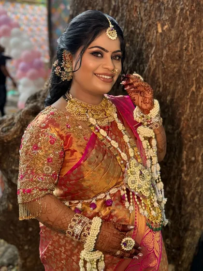 A joyful bride with beautiful floral jewellery in her hair, looking absolutely radiant.