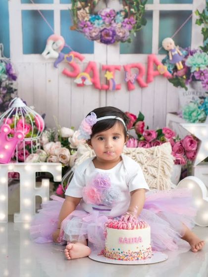 A beautiful first birthday setup with a personalized milestone board. This is a wonderful way to remember all the little things that made their first year so special.