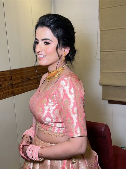 A side profile showing the simple, elegant updo and the flawless skin finish.