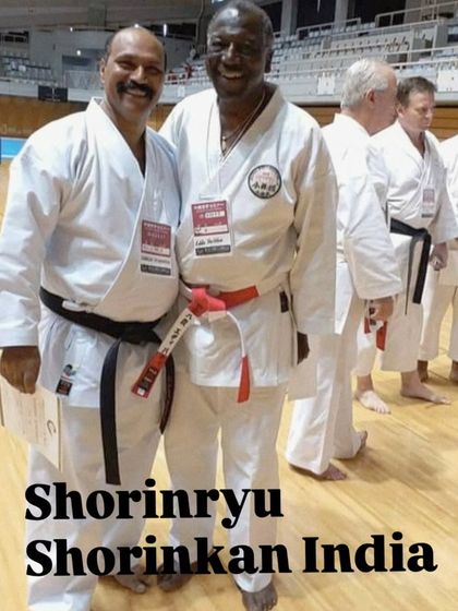A moment of camaraderie with a fellow karateka during a training seminar in Okinawa. The global karate community is built on mutual respect and a shared passion for the art.