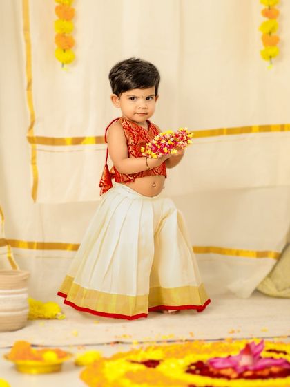 Celebrating Onam with this little cutie. Dressed in a traditional pattu pavadai, she is the star of this festive and colorful photoshoot.