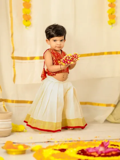 Celebrating Onam with this little cutie. Dressed in a traditional pattu pavadai, she is the star of this festive and colorful photoshoot.