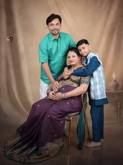 A beautiful family portrait celebrating the upcoming arrival. The family is dressed in traditional attire, creating a warm and cohesive image that honors their heritage.